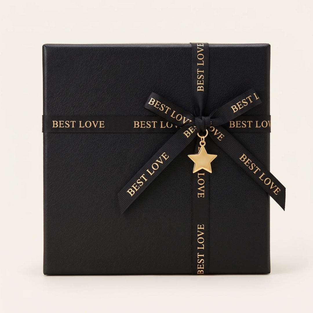 Black Monrich gift box tied with a ribbon and a gold star charm